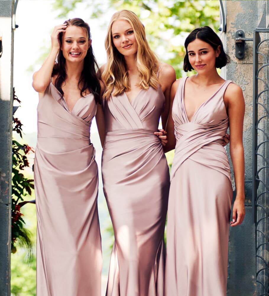 Bridesmaids wearing pastel pink dresses